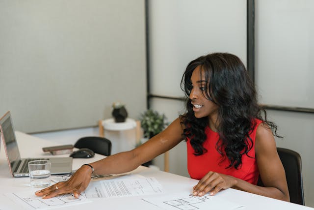 a property manager in a red shirt working at their desk