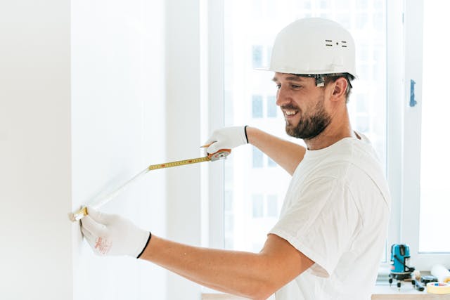 a contractor measuring a wall