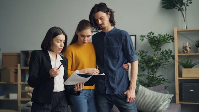 a landlord going over a contract with two tenants